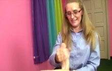 Older hoe with glasses on her knees to jerk